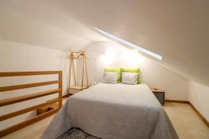 a bedroom with a bed with two green pillows at Casa do Casal - Country House with Swimming Pool in Viana do Castelo +36 photos
