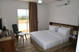Ένα ή περισσότερα κρεβάτια σε δωμάτιο στο Hôtel Corail de Cabo