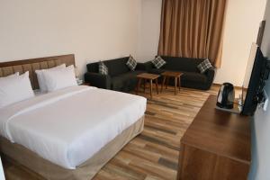 Ένα ή περισσότερα κρεβάτια σε δωμάτιο στο Hôtel Corail de Cabo