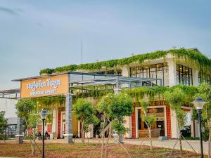 a building with plants growing on the side of it at Shanghai Resort in Bavet