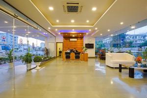 a lobby with white furniture in a building at Rama Trident, Katra in Katra
