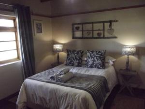 Postel nebo postele na pokoji v ubytování Karsrivier Cottage