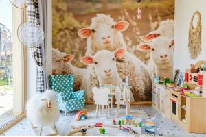 a room with a painting of a group of sheep at Panocek in Białka Tatrzańska