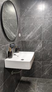 a bathroom with a white sink and a mirror at Pension Irene in Sougia