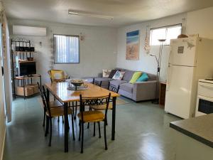 a kitchen and living room with a table and chairs at Leander Reef Holiday Park in Port Denison