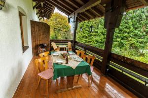 a table and chairs on the porch of a house at Ferienwohnungen am Märchenpark in Marquartstein +17 photos