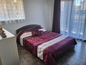 a bedroom with a bed with a purse on it at Tac Premier in Ventspils