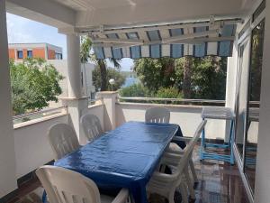 a blue table and chairs sitting on a porch at Apartmani Auer in Pješčana Uvala