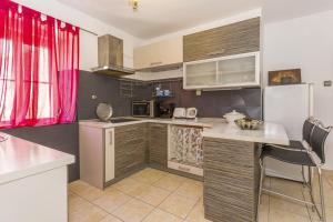 a kitchen with a counter and a table in it at North wall apartment in Split