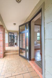 an entrance to a house with sliding glass doors at Igna in Eersterivierstrand