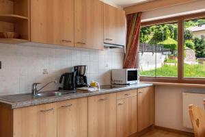 a kitchen with a sink and a microwave at Hotel Residence Gardena Sella in Santa Cristina Gherdëina