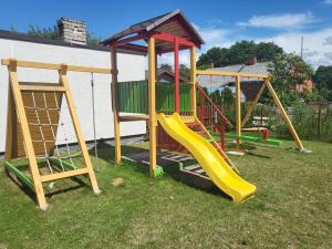 a playground with a slide and a play structure at Tac Premier in Ventspils