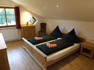 a bedroom with a bed with two pillows on it at Landhaus Brockhaus in Rettenberg