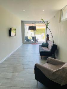 a living room with a couch and chairs and a table at appartement saint juery in Arthès +12 photos
