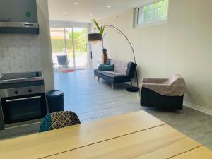 a living room with a couch and chairs and a table at appartement saint juery in Arthès