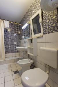 a bathroom with a toilet and a sink at Apartments Pika in Krk