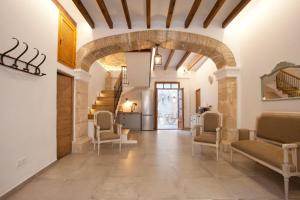 a hallway in a house with an archway and chairs at My Rooms Artà Adults Only by My Rooms Hotels in Artá