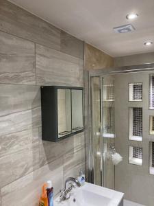 a bathroom with a sink and a shower at London retreat in Golders Green