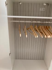 a closet with hangers and baseball bats in it at London retreat in Golders Green