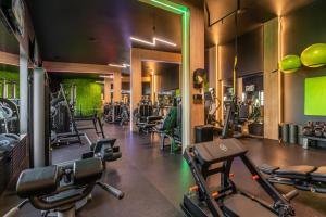 a gym with several treadmills and weights at JJ Sport Concept Hotel in Kraków