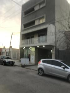 a silver car parked in front of a building at Remedios de escalada Suite! Wifi Aire cable in Villa María