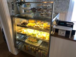 a refrigerator filled with lots of different types of food at Bredsjö Gamla Herrgård White Dream Mansion in Hällefors