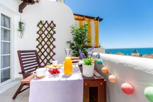 stół z jedzeniem na balkonie z widokiem na ocean w obiekcie Apartment Pueblo Quinta w mieście Benalmádena