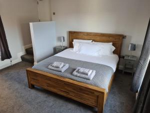 a bedroom with a bed with two towels on it at Tramway hotel in Pakefield