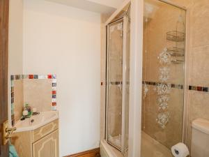 a bathroom with a shower and a sink at The Cottage in Mapperley +15 photos