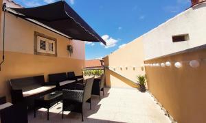 a patio with chairs and a table on a building at Apartment Decumana in Krk