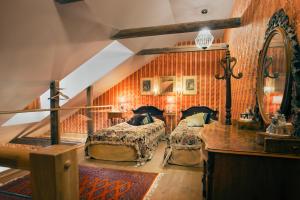 a bedroom with two beds and a desk and a staircase at Börsen Apartment Suites in Visby