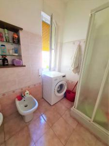 a bathroom with a white toilet and a sink at Appartamento Il Cigno in Rapallo