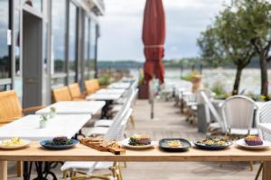 a wooden table with plates of food on it at Hôtel De La Vallée in Dinard