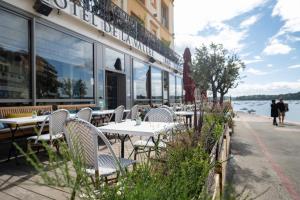 a row of tables and chairs outside of a restaurant at Hôtel De La Vallée in Dinard
