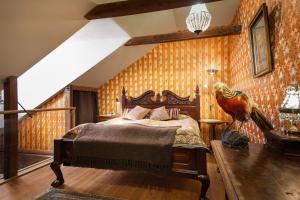 a bedroom with a bed with a parrot on the wall at Börsen Apartment Suites in Visby +19 photos