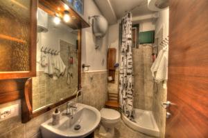 a bathroom with a sink and a toilet and a shower at Casa Mastarna in Canino