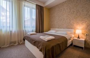 a bedroom with a bed with towels on it at New Gudauri Suites N317 in Gudauri