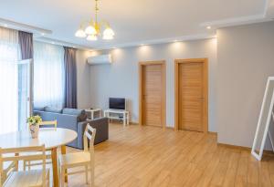 a living room with a couch and a table at Apartment By The Sheraton in Batumi