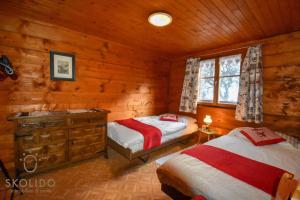 a bedroom with two beds in a log cabin at Cosy Chalet in Brig-Glis in Glis