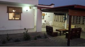 a patio of a house with a table and chairs at Casa vacanze immersa nelle campagne salentine in Monacizzo