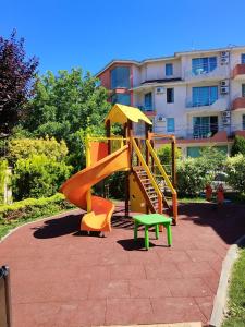 a playground with a slide in front of a building at Marina Studio in Ravda