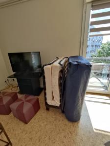 Televízia a/alebo spoločenská miestnosť v ubytovaní Nid douillet au coeur de Rosendael,très bien situé