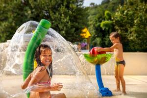 two young children playing in a water park at Hotel Marina - Liburnia in Mošćenička Draga
