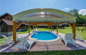 a gazebo with chairs and a swimming pool at Lovely Home In Cacinci With House A Panoramic View in Čačinci