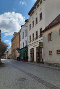 an empty street in a city with buildings at APARTAMENTY TR 11 Apartament nr 3 in Olsztyn