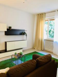uma sala de estar com um sofá e um tapete verde em appartmentslapiazzetta - n.4 em Sesto Calende