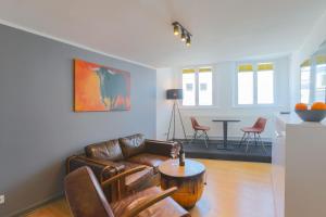 a living room with a couch and a table at Apartments im Einhornhaus in Lübeck +71 photos