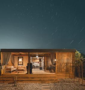 una casa in legno con terrazza di notte di Luxury home Alpha, pool, camp Volme - nearby Kamenjak a Banjole