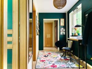 a hallway with green walls and a rug in a room at Three bedroom with two terraces for 7people+baby in Kaunas