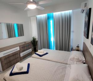 a bedroom with two beds with towels on them at Lovely 1-bedroom unit @ fabulous location in Paphos City